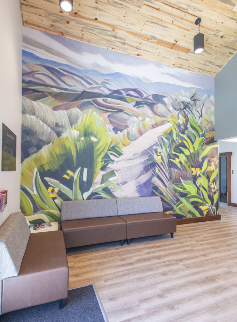 Lounge with a painted landscape mural at the Idaho Youth Ranch Hands of Promise Campus
