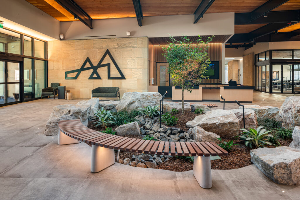 Lobby of the Idaho Outdoor Fieldhouse in Boise with a curved bench and planting
