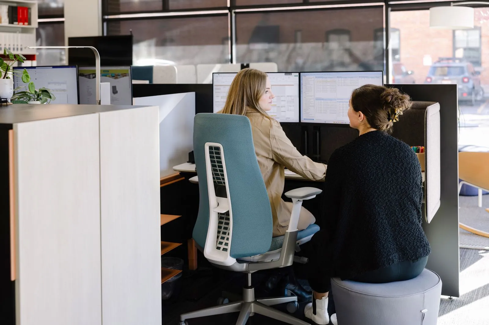 Mesh task chairs at open workstations with monitor arms in the Freeform Boise showroom