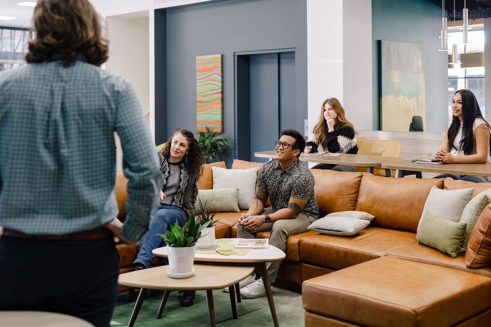 Group conversation across lounge seating in the showroom