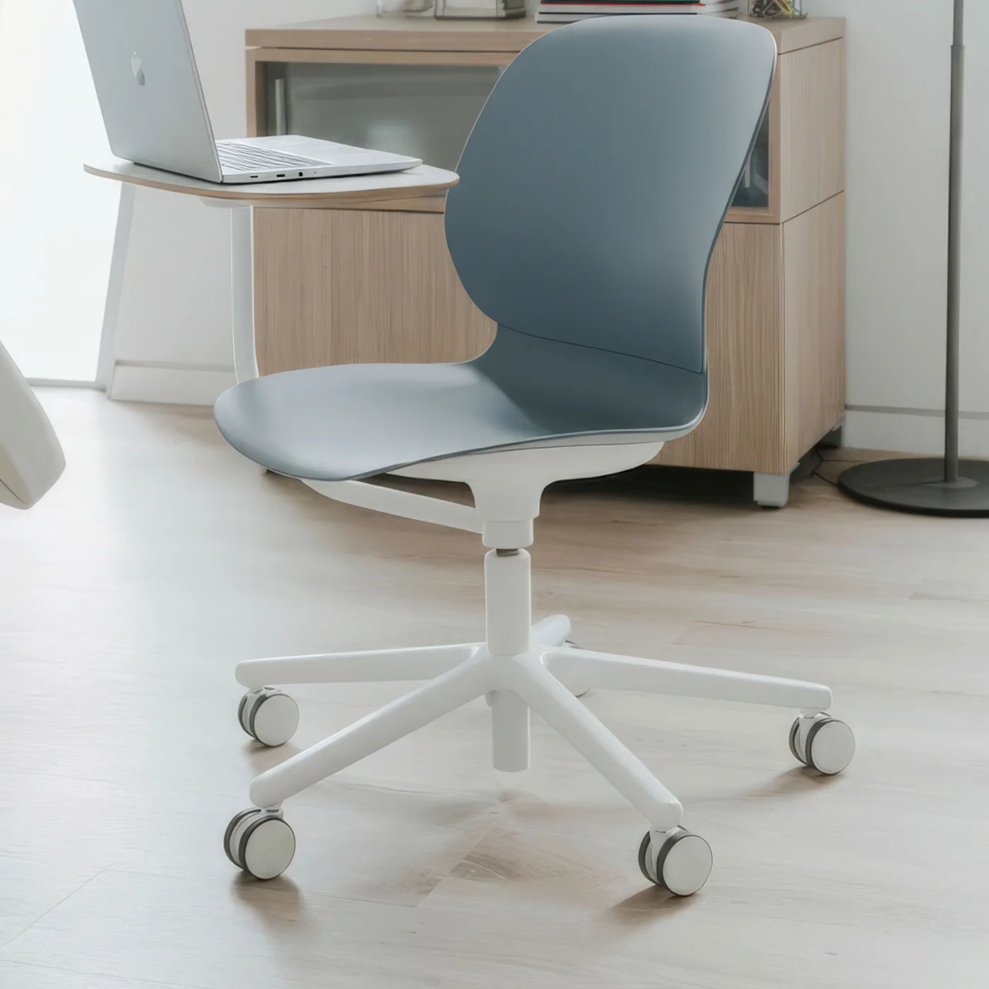 Haworth Maari exam stool with bleach-cleanable shell, casters and tablet arm in a consult room