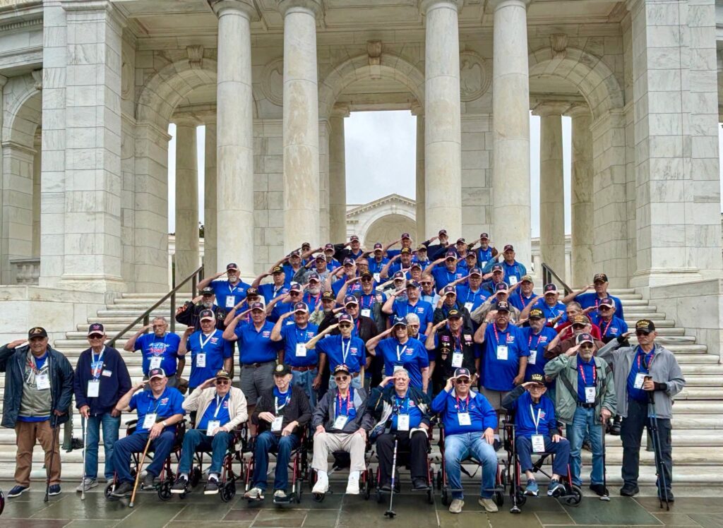 Honor Flight veterans on the steps of a memorial in Washington, D.C.