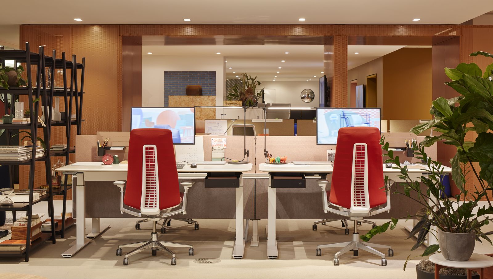 Showroom workstations with red task chairs and wood shelving