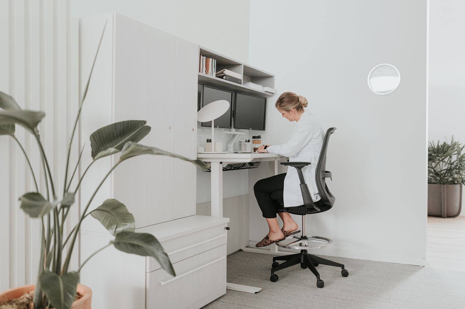 Employee working at a raised height-adjustable desk