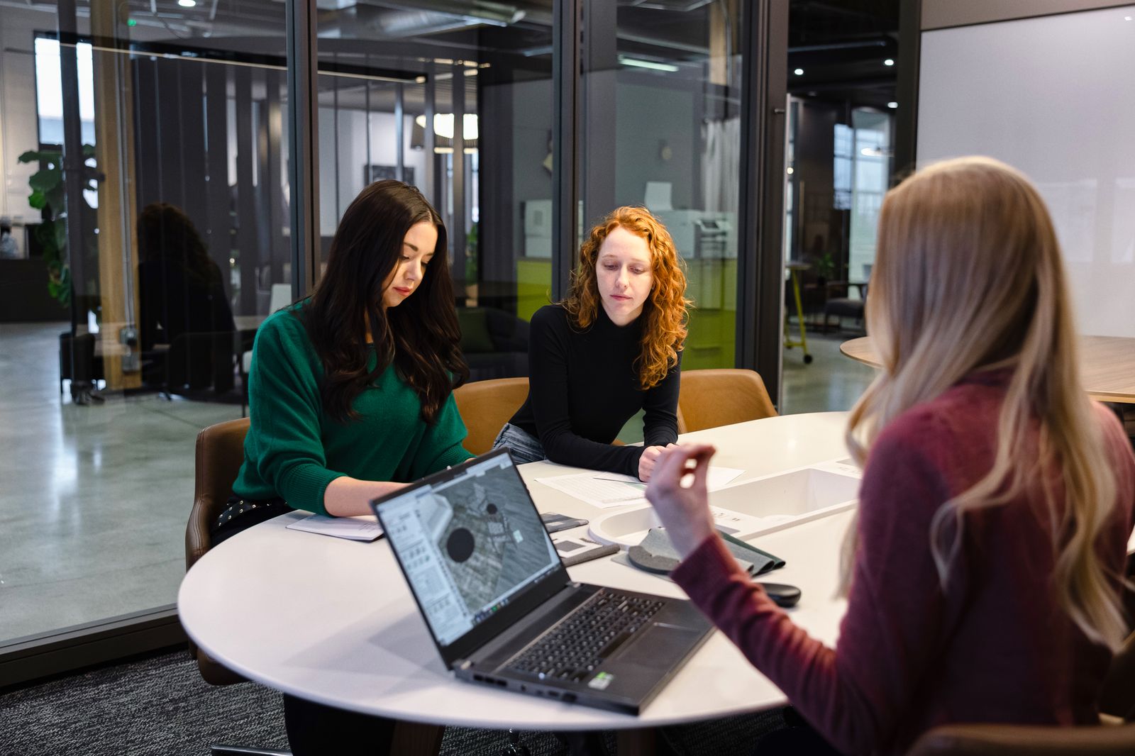 Team members laughing during a meeting at a round table